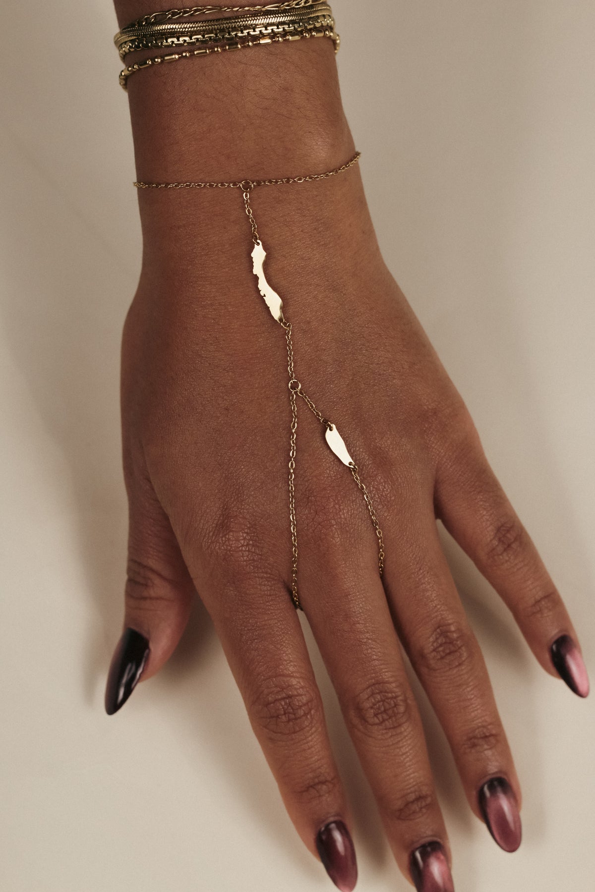Gold OG Curaçao Hand Chain jewelry with original Curaçao and Klein Curaçao silhouettes