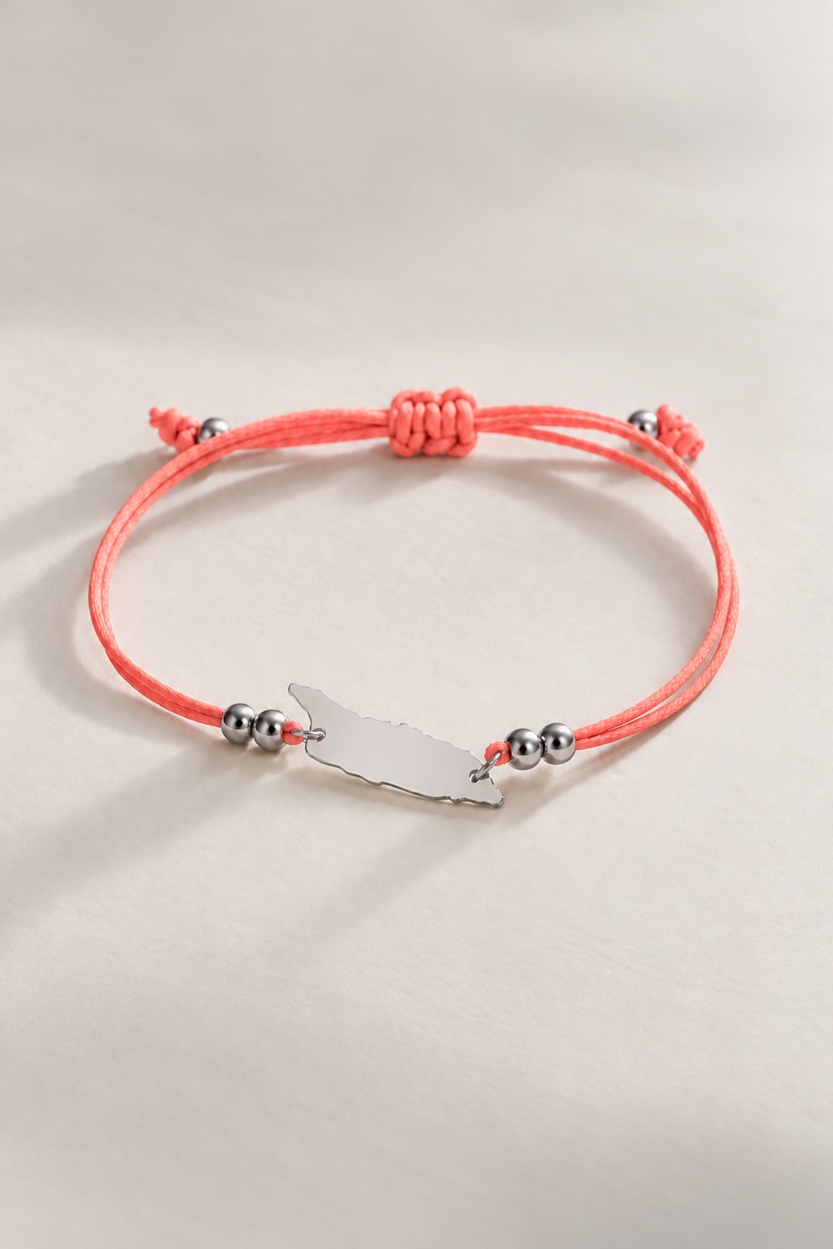 Coral Aruba cord bracelet with silver-tone details