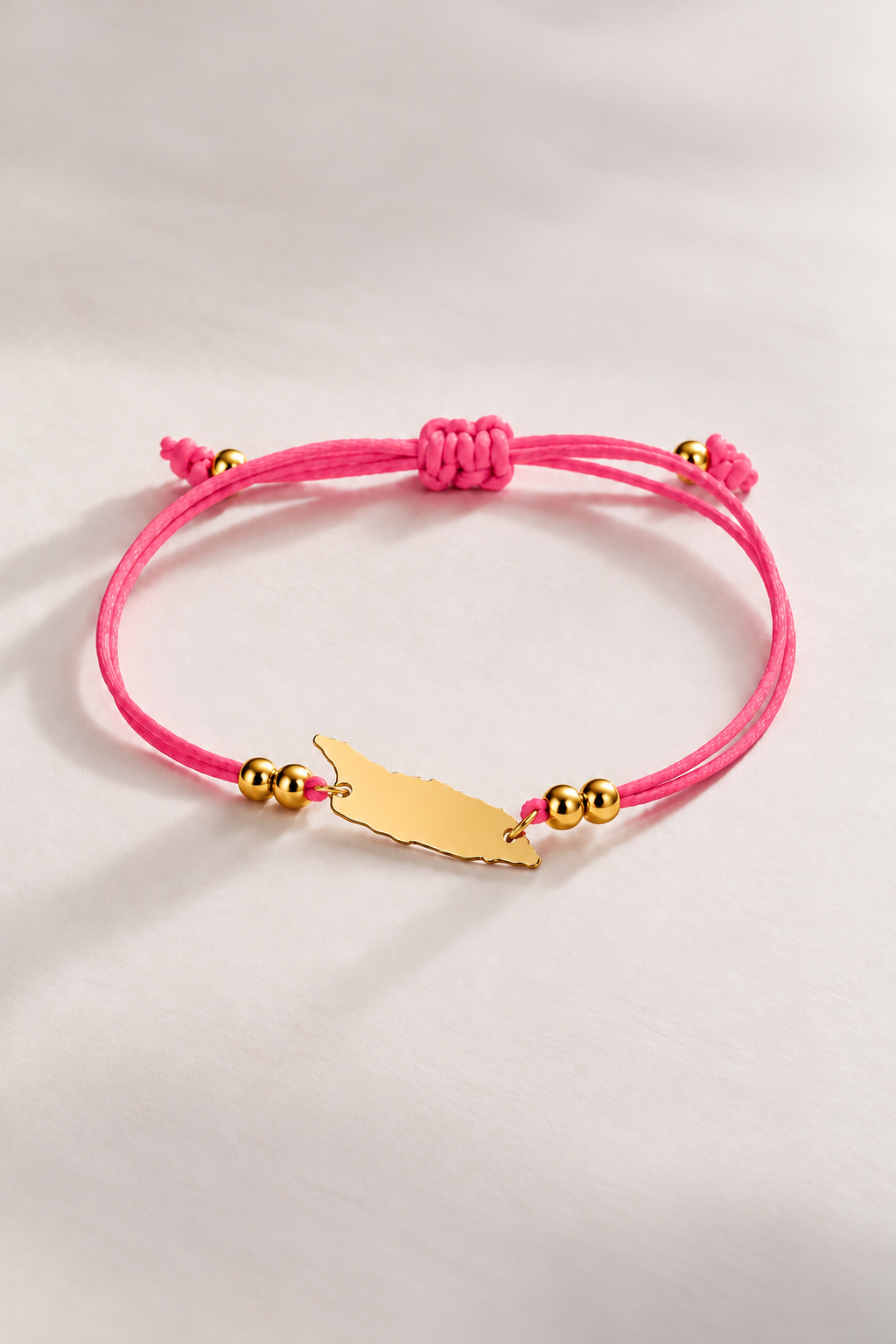 Hot pink Aruba cord bracelet with gold-tone details