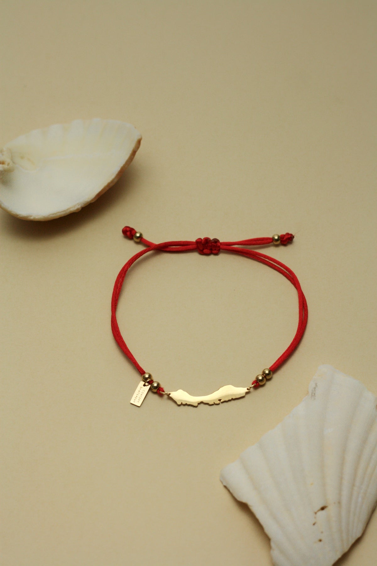 Red satin cord bracelet with Curaçao island charm