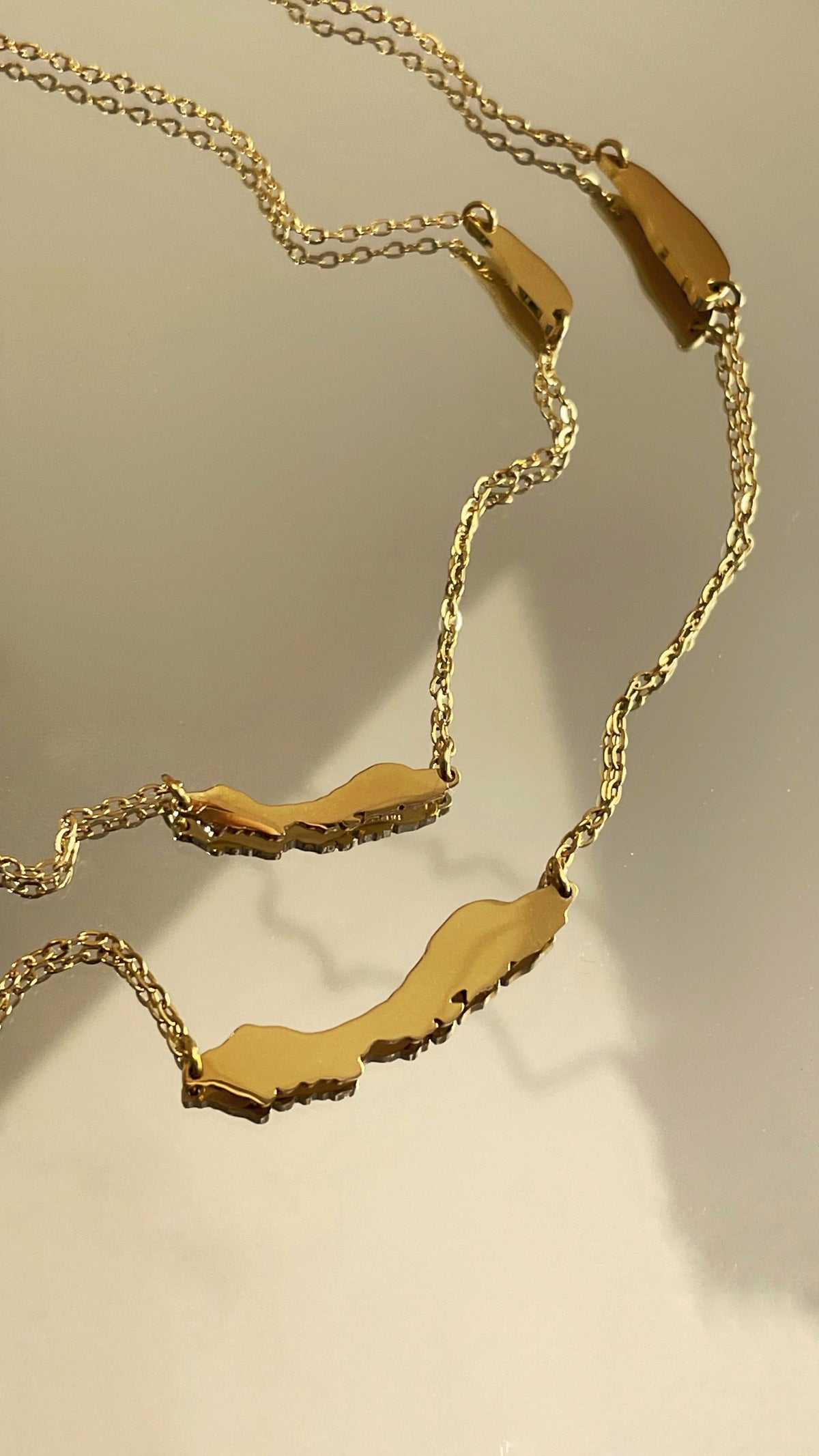 Gold-plated OG Petite Curaçao necklace with two island silhouettes