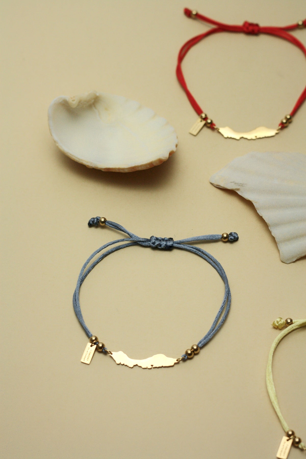 Curaçao cord bracelets in blue gray, red and yellow