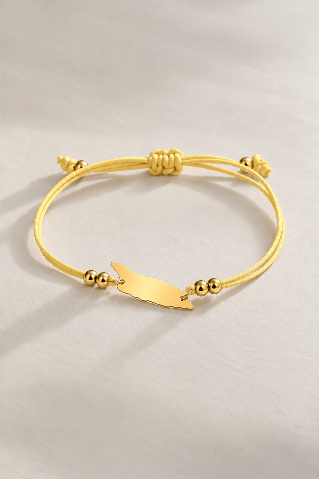 Light yellow Aruba cord bracelet with gold-tone details