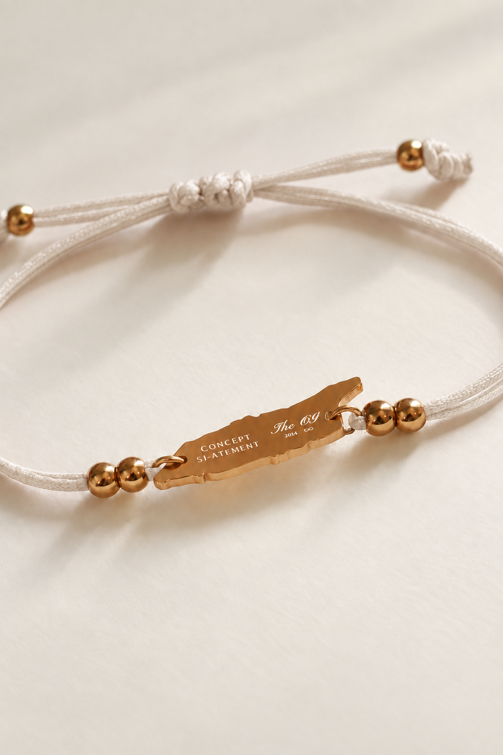 Back of seashell cream Aruba bracelet showing engraved island charm