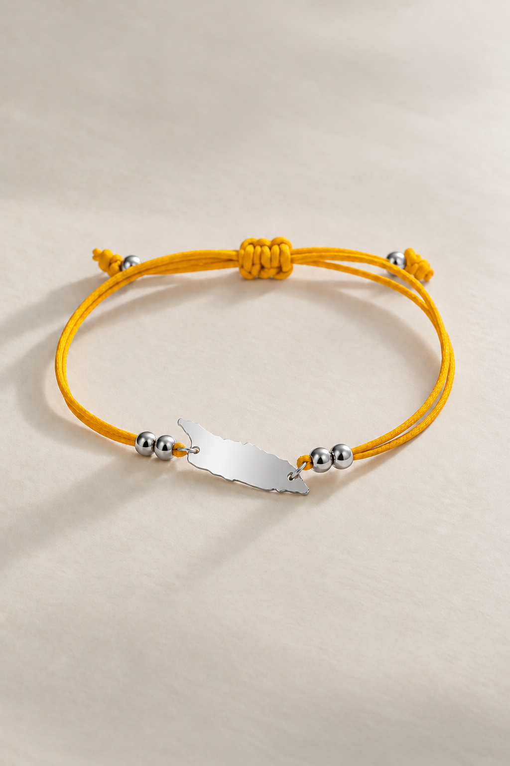 Pumpkin yellow Aruba cord bracelet with silver-tone details