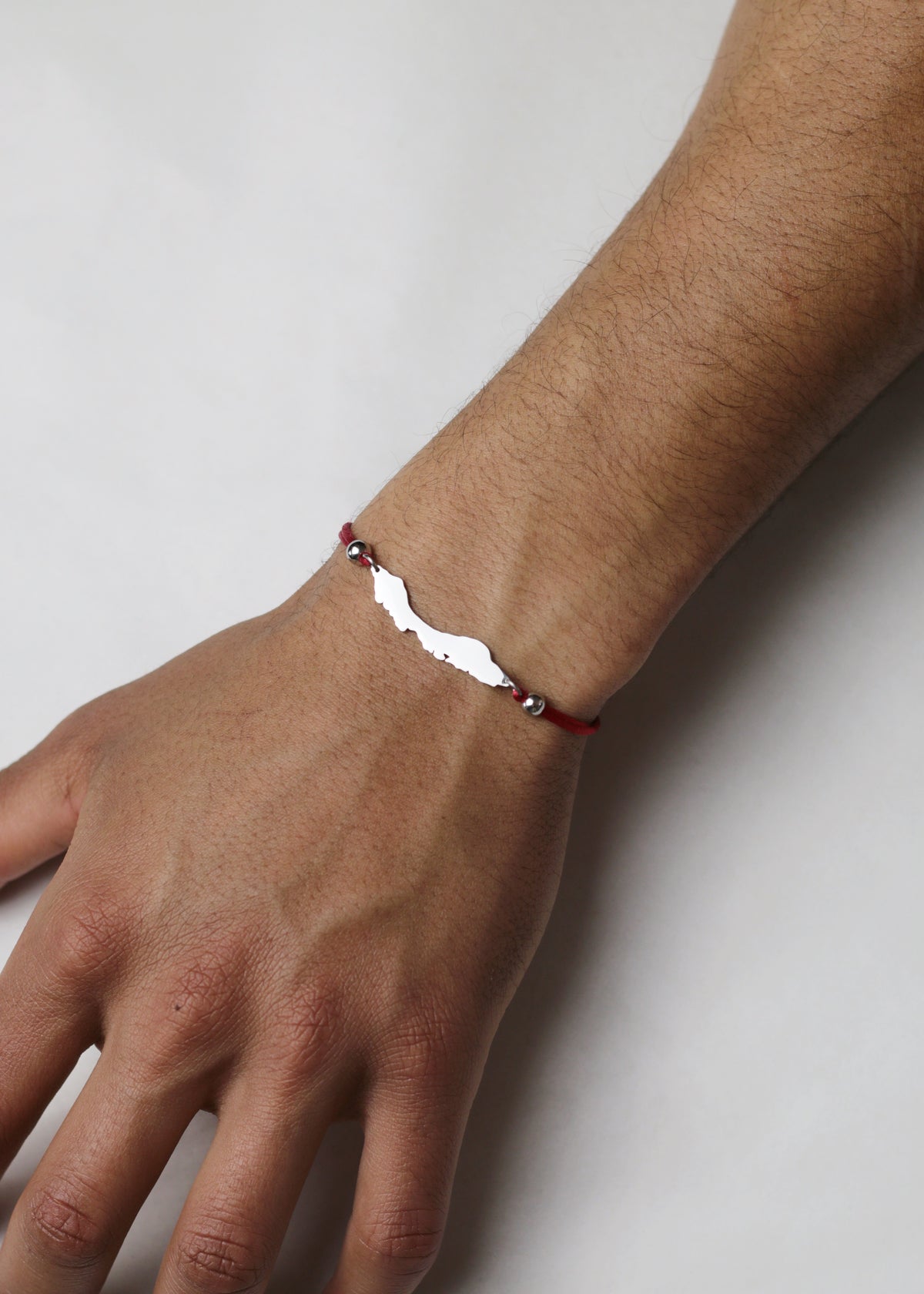 Deep red men's Curaçao cord bracelet with silver-tone island charm